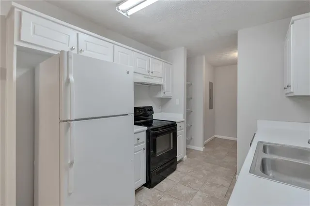 a kitchen with a refrigerator and a sink