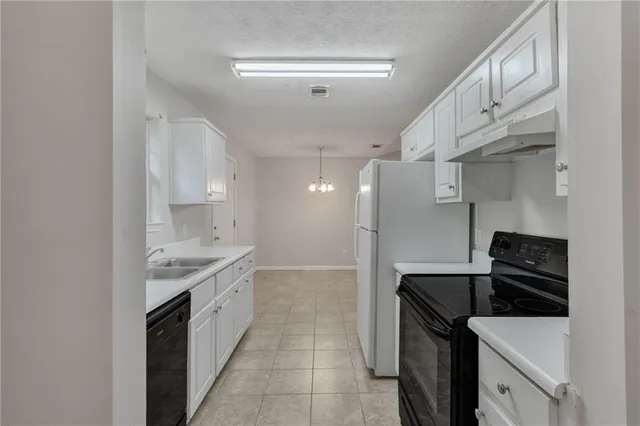 a kitchen with a sink and a stove