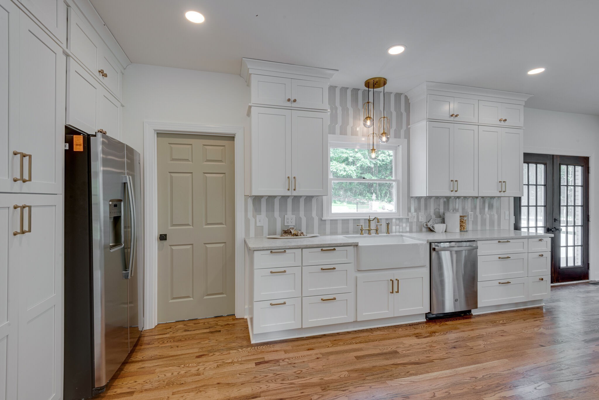 325 East Piney Road Dickson, TN 37055 - Photo 22 of 63 a kitchen with stainless steel appliances white cabinets and wooden floors