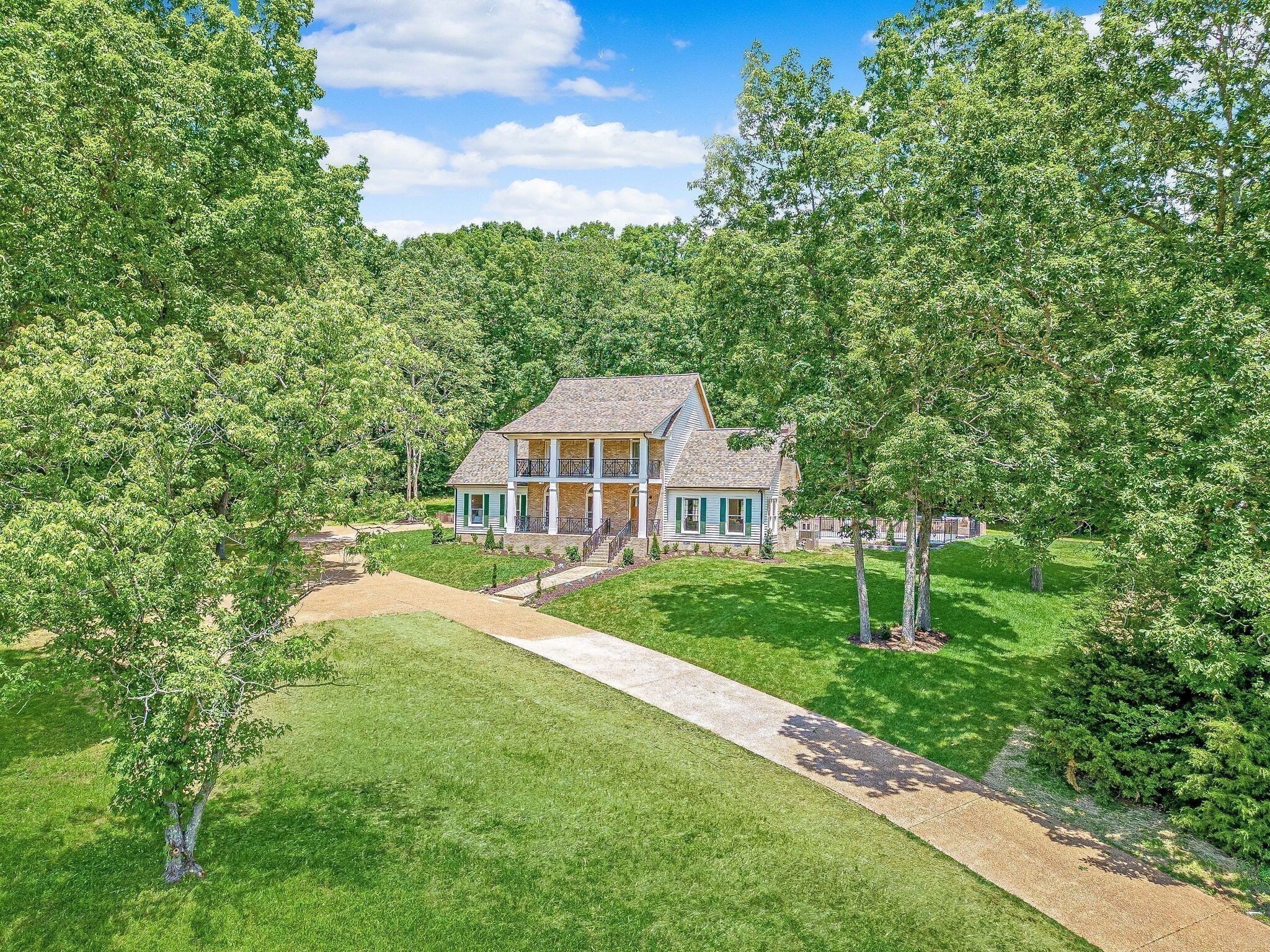 325 East Piney Road Dickson, TN 37055 - Photo 5 of 63 a view of a house with a big yard potted plants and large tree