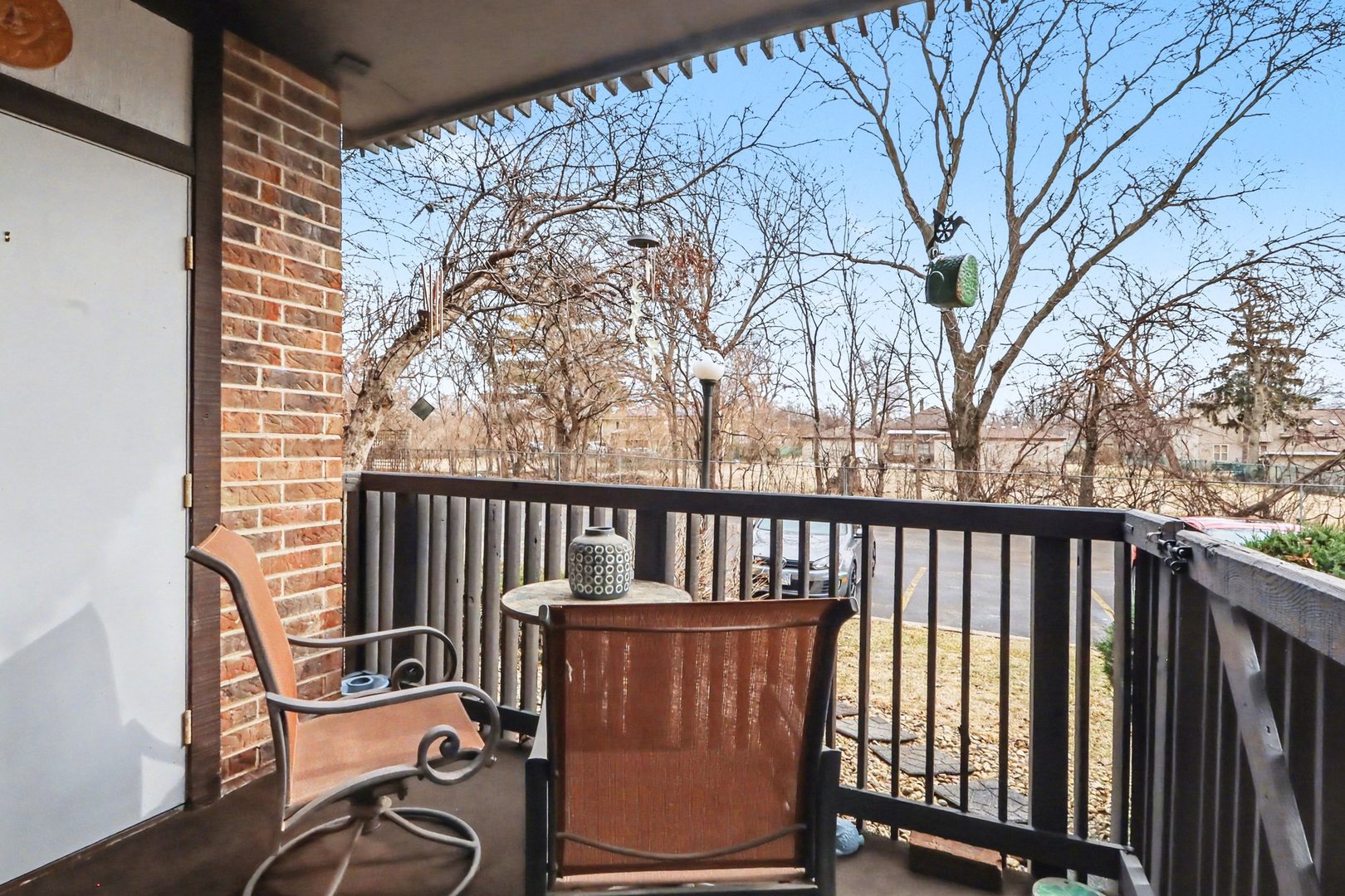 1423 Woodbridge Road, Unit 1E Joliet, IL 60436 - Photo 19 of 30 a view of a chair and table in the balcony