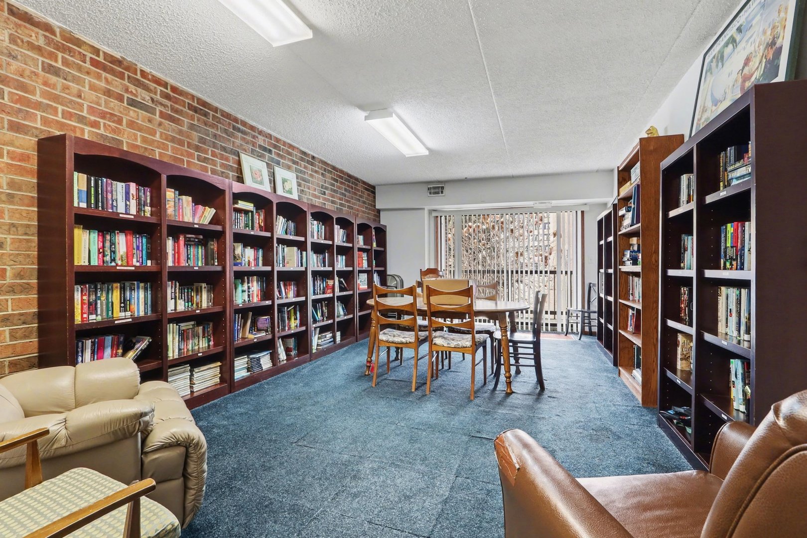 1423 Woodbridge Road, Unit 1E Joliet, IL 60436 - Photo 21 of 30 a living room with furniture and a book shelf