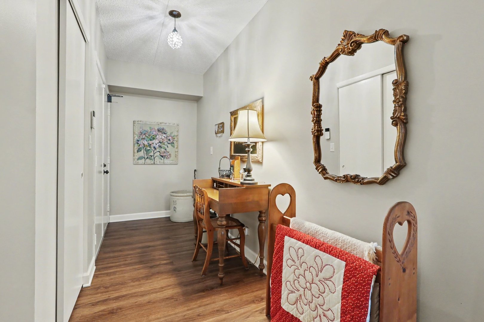 1423 Woodbridge Road, Unit 1E Joliet, IL 60436 - Photo 4 of 30 a view of a hallway with wooden floor and furniture