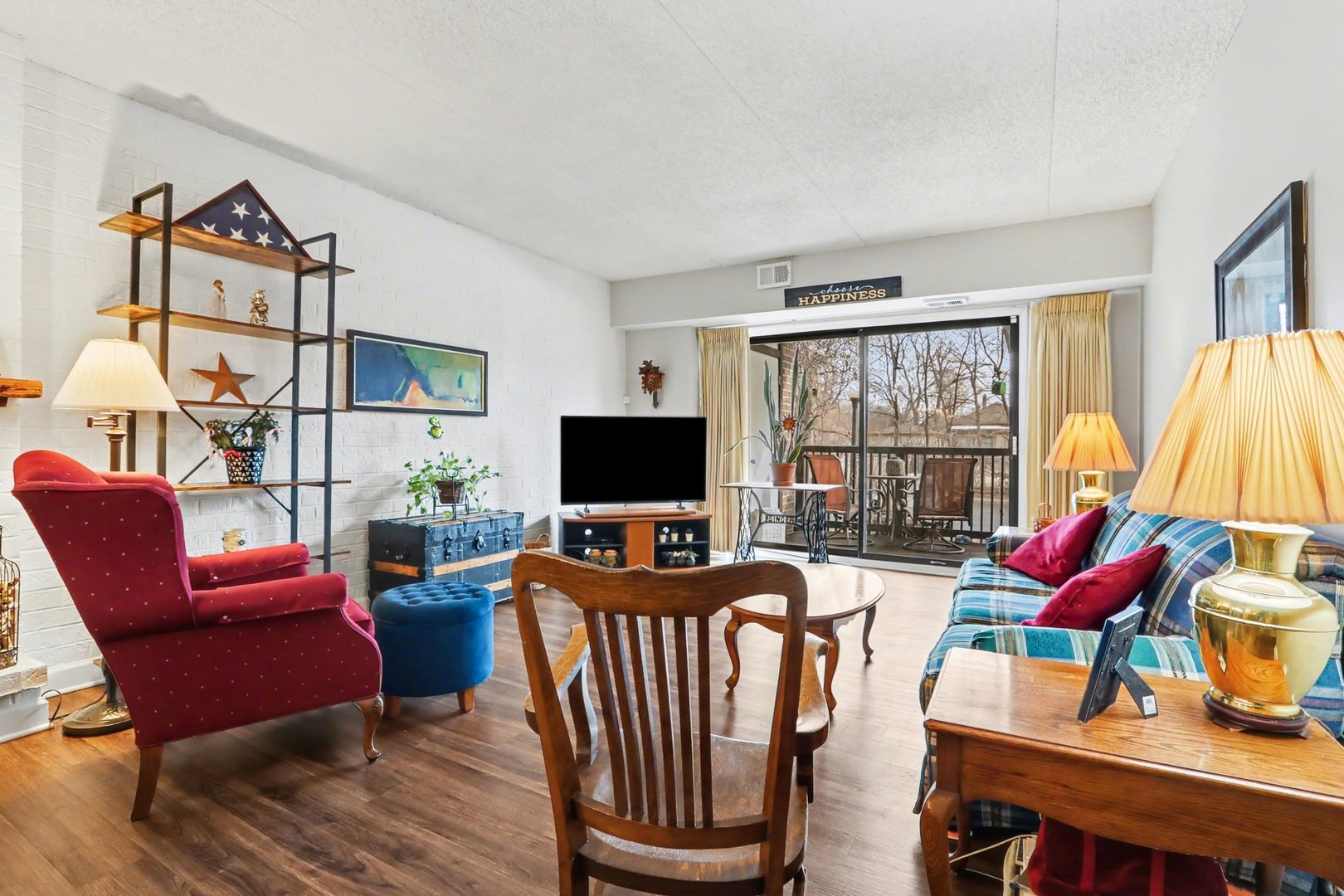 1423 Woodbridge Road, Unit 1E Joliet, IL 60436 - Photo 5 of 30 a living room with furniture a flat screen tv and a large window