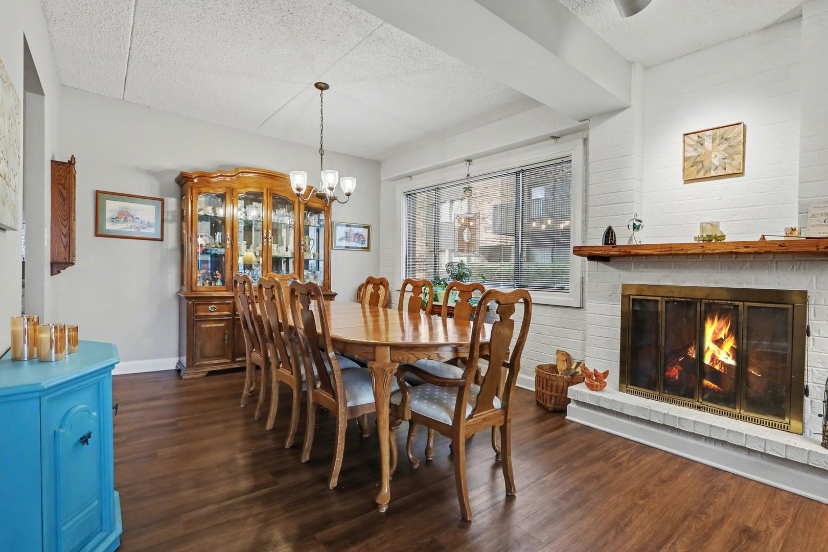 1423 Woodbridge Road, Unit 1E Joliet, IL 60436 - Photo 7 of 30 a dining room with furniture window fireplace and wooden floor
