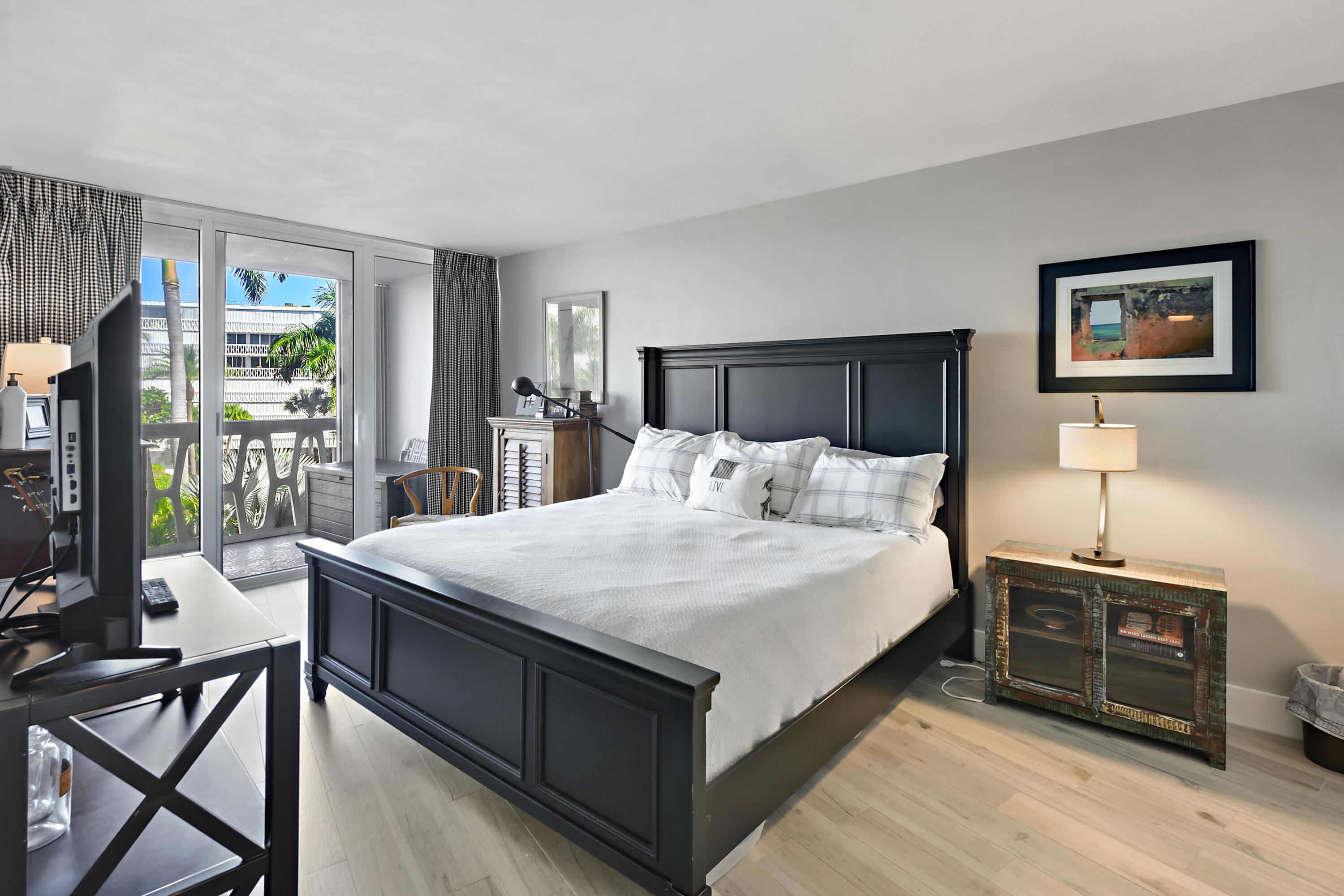 2505 South Ocean Boulevard, Unit 411 Palm Beach, FL 33480 - Photo 12 of 31 a bed room with a bed and a tv