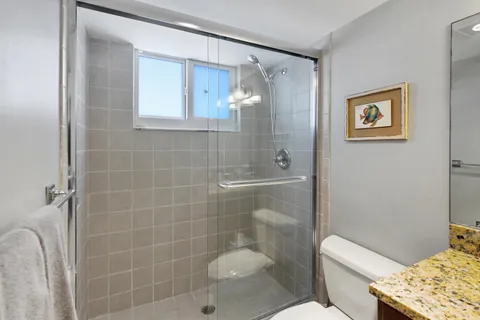 a bathroom with a toilet sink and shower