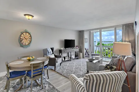 a living room with furniture a large window and a flat screen tv
