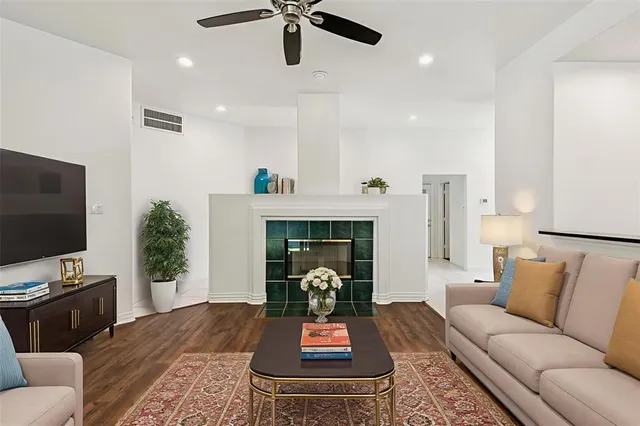 a living room with furniture fireplace and flat screen tv