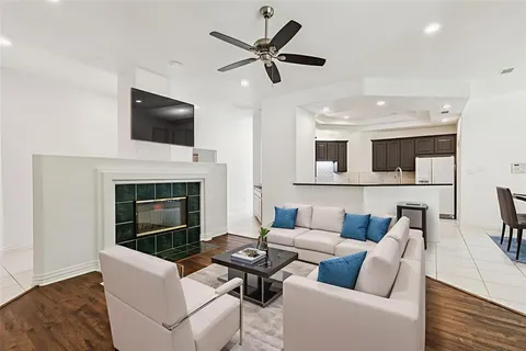 a living room with furniture fireplace and a flat screen tv