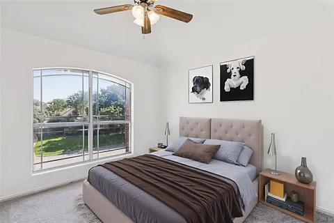 a bedroom with a bed and a window