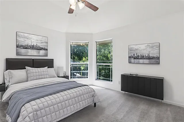 a bedroom with a large bed and a lamp on table