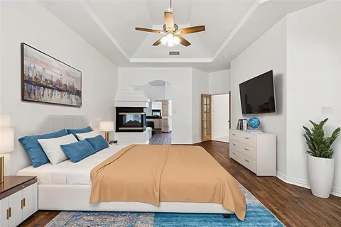 a bedroom with a bed and a flat screen tv