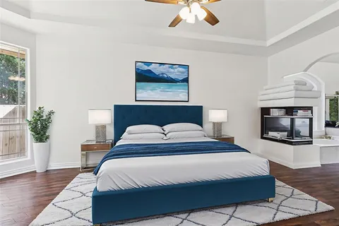 a bedroom with a large bed and a fireplace