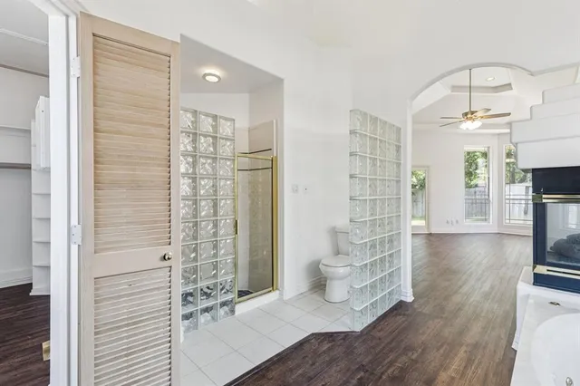 a view of empty room with wooden floor and fireplace