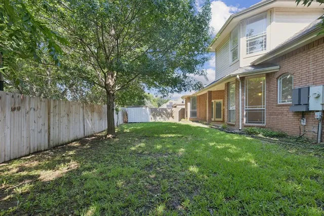a view of a house with a backyard