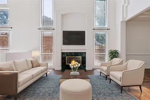 a living room with furniture a fireplace and a flat screen tv
