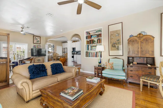 a living room with furniture a rug and a chandelier