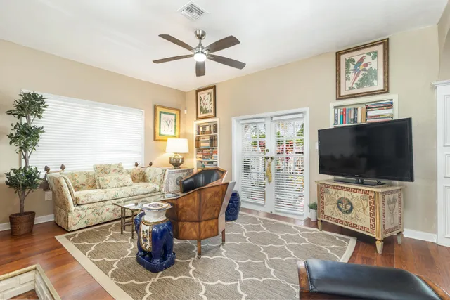 a living room with furniture a flat screen tv and a flat screen tv