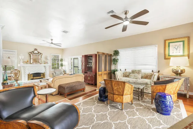 a living room with furniture kitchen view and a large window