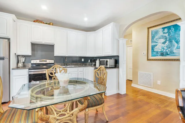 a kitchen with a sink a stove and a refrigerator