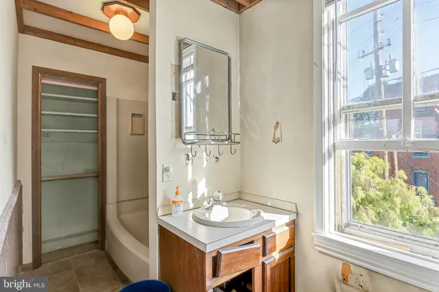 a bathroom with a sink vanity and a mirror