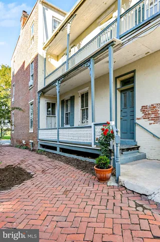 a bunch of flowers in front of a house