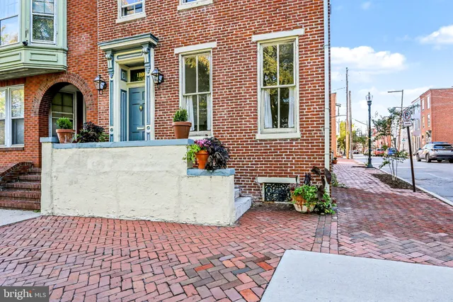 a view of a brick house with many windows