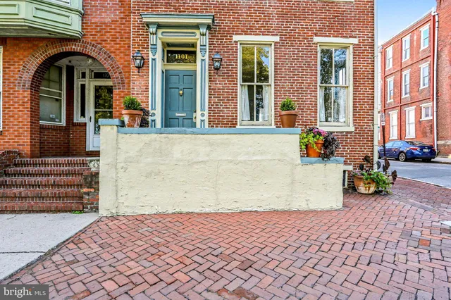a view of a brick house with many windows
