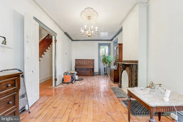 a living room with furniture a fireplace and a chandelier