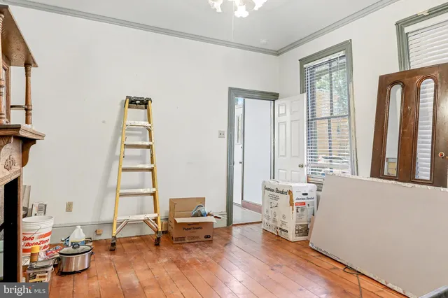 a living room with furniture and two window