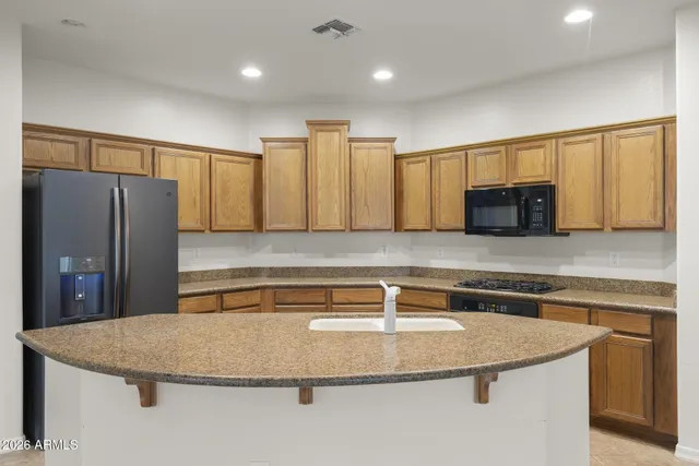 a kitchen with kitchen island a sink and stainless steel appliances