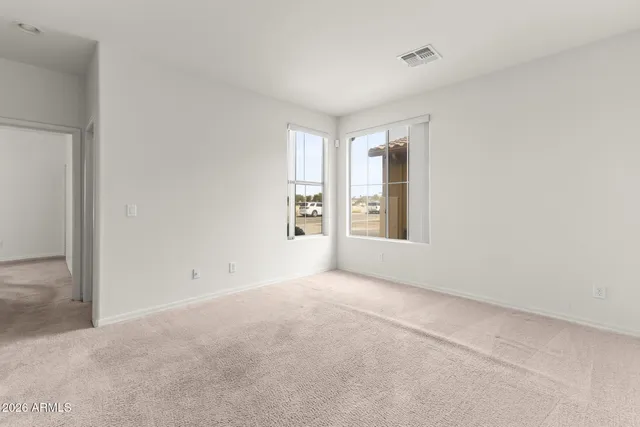 an empty room with windows and closet