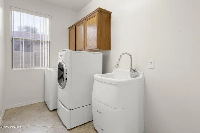 a bathroom with a sink and washing machine