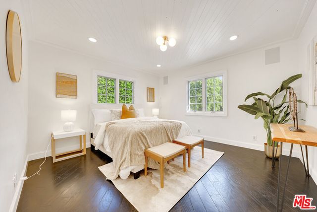 a bed room with a bed and a chair