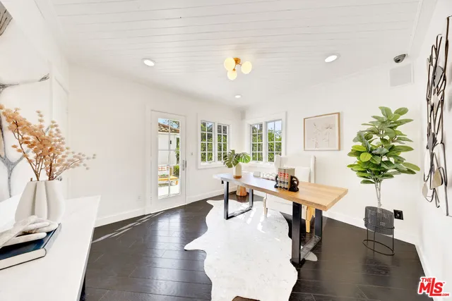 a workspace with furniture window and wooden floor