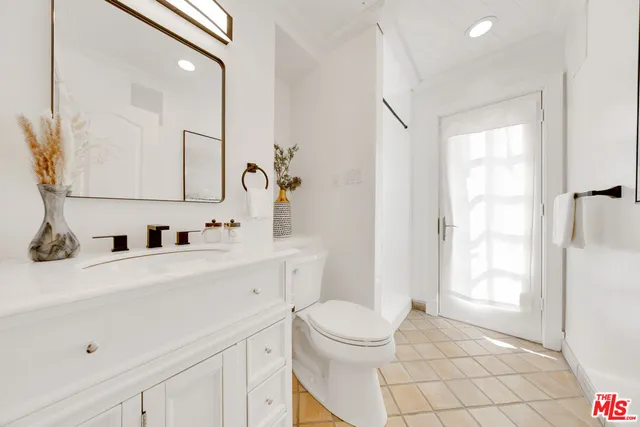 a bathroom with a sink a toilet and vanity