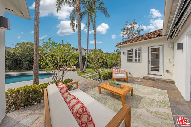 a view of a house with backyard and sitting area