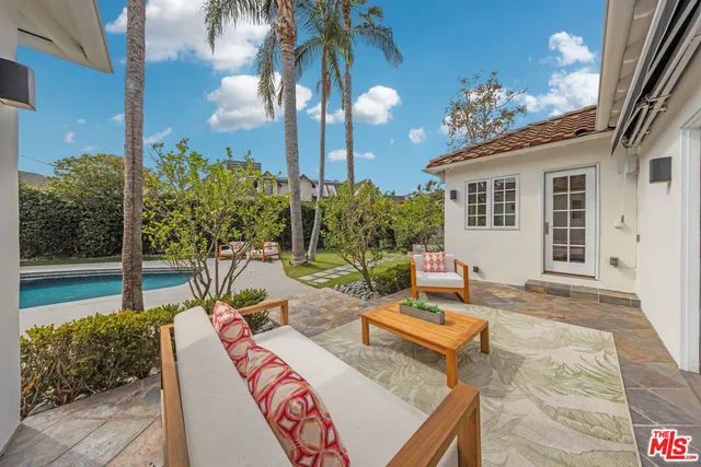 a view of a house with backyard and sitting area