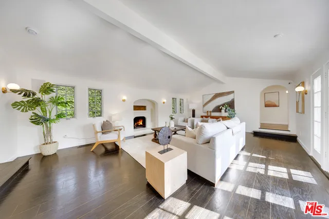 a living room with fireplace furniture and a wooden floor