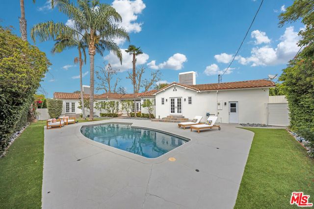 a view of a house with swimming pool and sitting area