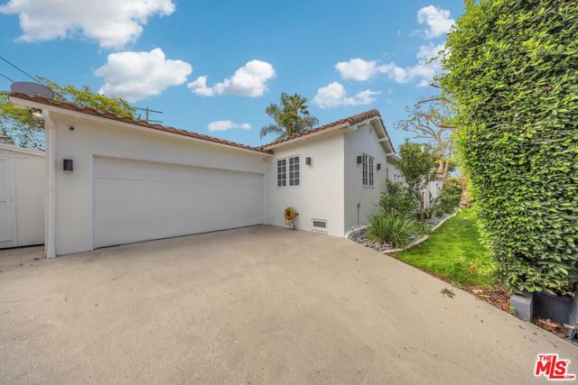 a view of a house with a backyard and a garden