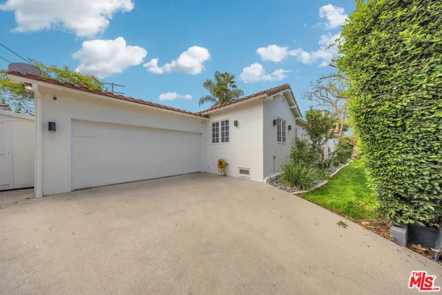 a view of a house with a backyard and a garden