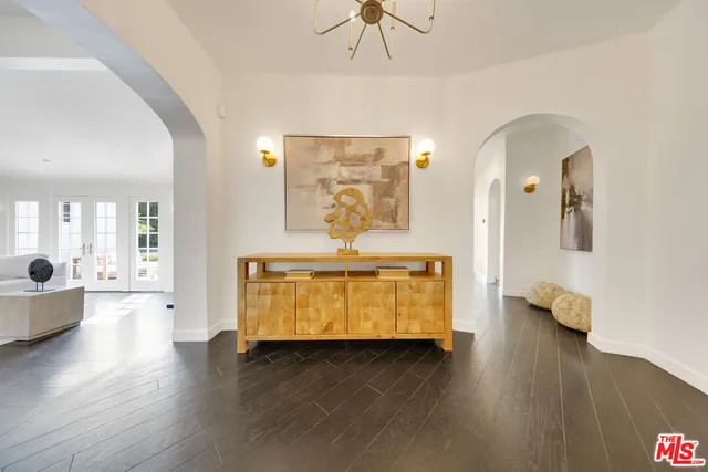 a living room with couches and wooden floor