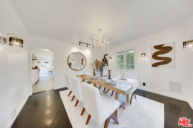 a living room with table and chairs