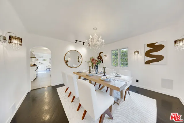 a living room with table and chairs