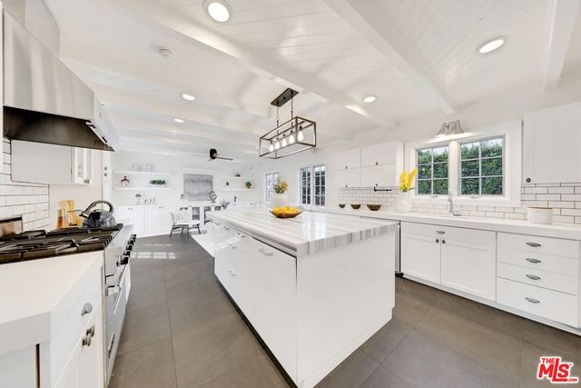 a kitchen with cabinets and window