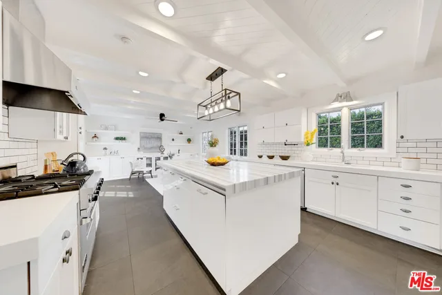 a kitchen with cabinets and window
