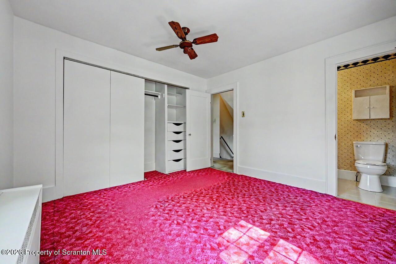 502 Layton Road Clarks Summit, PA 18411 - Photo 25 of 42 a bedroom with a large bed and a chandelier
