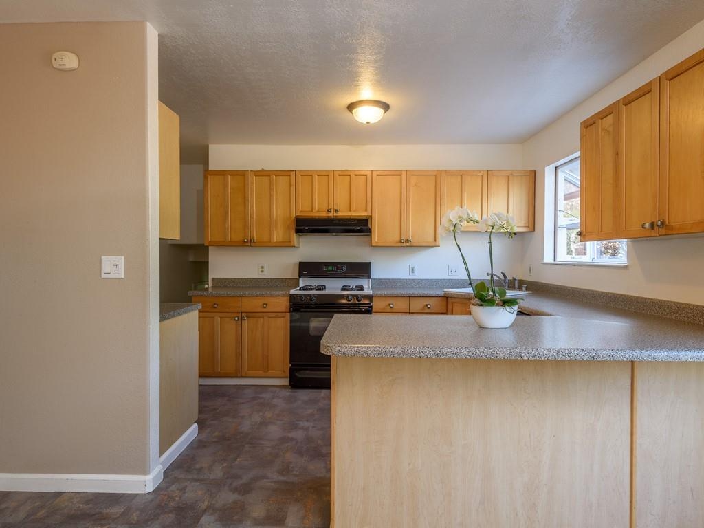 571 Lancaster Boulevard Moss Beach, CA 94038 - Photo 5 of 16 a kitchen with granite countertop a sink cabinets and stainless steel appliances